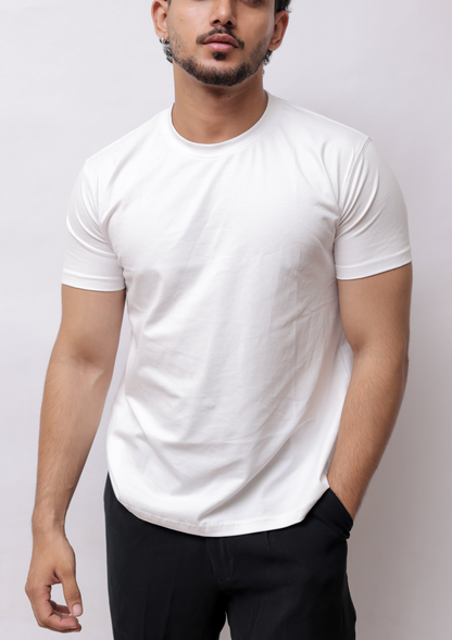 A man wearing a white short-sleeve crewneck t-shirt and black pants, shown from a high-angle side profile against a plain light gray background.
